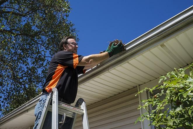 a construction worker repairing a damaged gutter in Cottonwood, CA